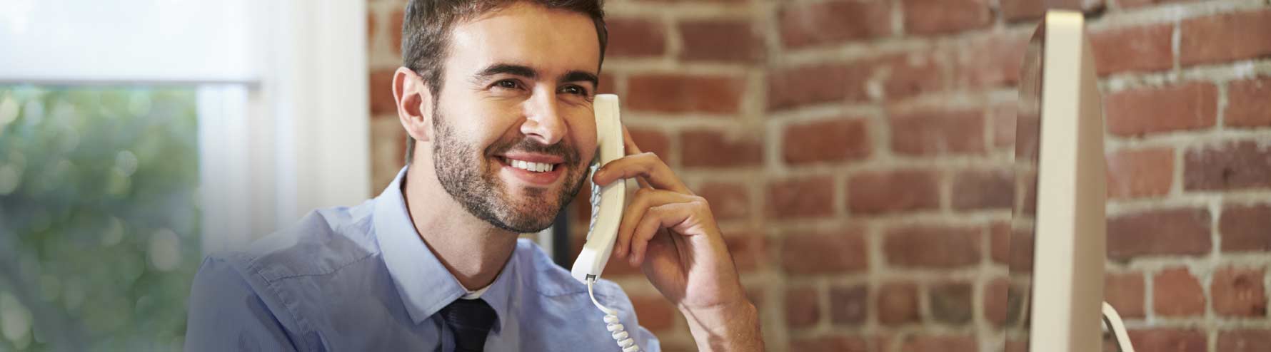 Smiling business man on phone in office
