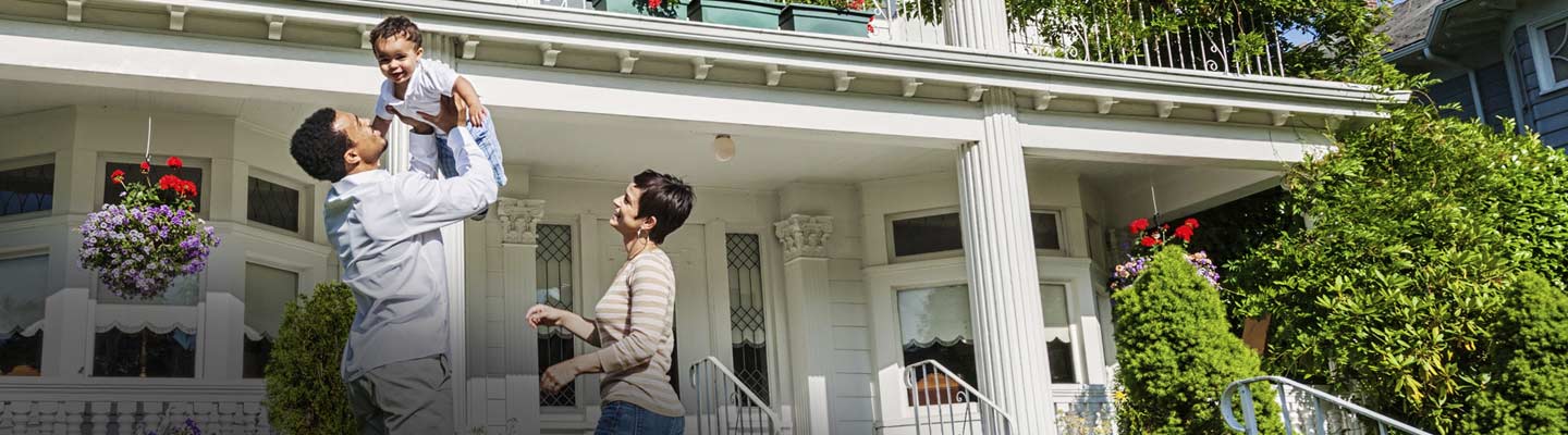 Family in front of home