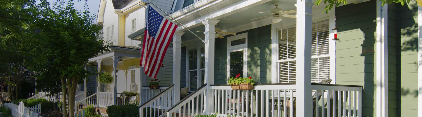 Front porch of home with American flag displayed